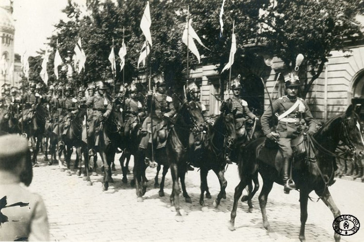 Szwadron 2. Pułku Ułanów Legionów Polskich wyjeżdża z Placu Saskiego. W tle widoczny budynek Hotelu Europejskiego, w głębi sobór św. Aleksandra Newskiego. Warszawa. Wiosna 1917 r. Źródło: CAW