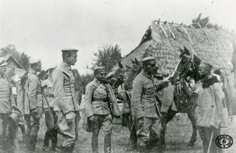 Komendant Józef Piłsudski (drugi od prawej) wizytuje 1 Pułk Ułanów Legionów Polskich. Na zdjęciu między innymi: por. Bolesław Długoszowski ps. „Wieniawa” (pierwszy od lewej), ppor. Michał Fuksiewicz, Emil Mieszkowski. Wołyń. 1916 r. Źródło: CAW