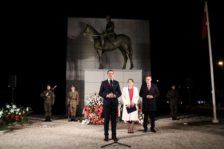 Premier Mateusz Morawiecki (L), poseł PiS Arkadiusz Mularczyk (P) i kandydatka Zjednoczonej Prawicy na prezydenta miasta Iwona Mularczyk (2P) po złożeniu kwiatów przed pomnikiem Józefa Piłsudskiego w Nowym Sączu. Fot. PAP/G. Momot